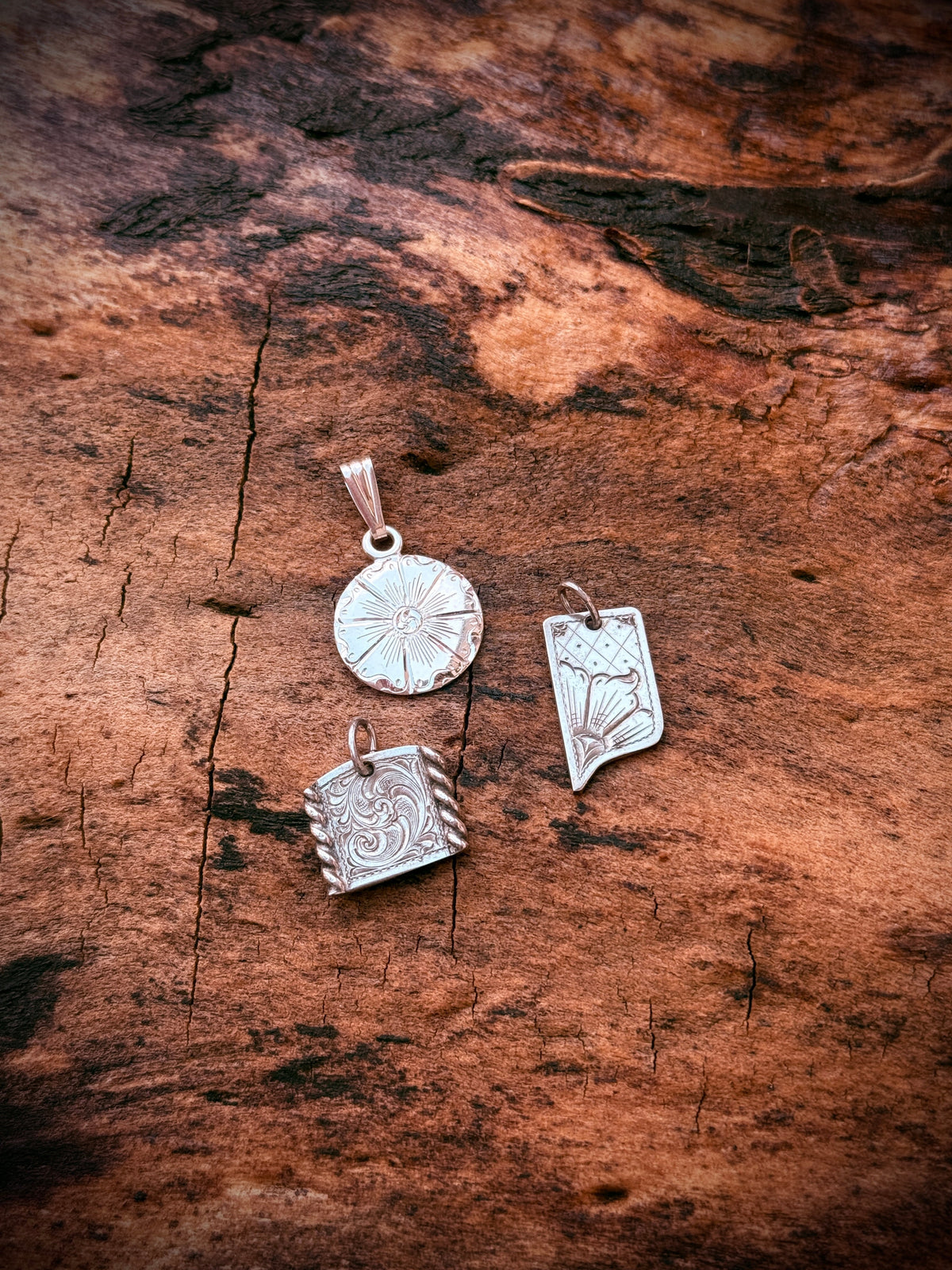 Hand-engraved sterling silver pendants: Open Range Round, Sierra Drop and Ranch Arch