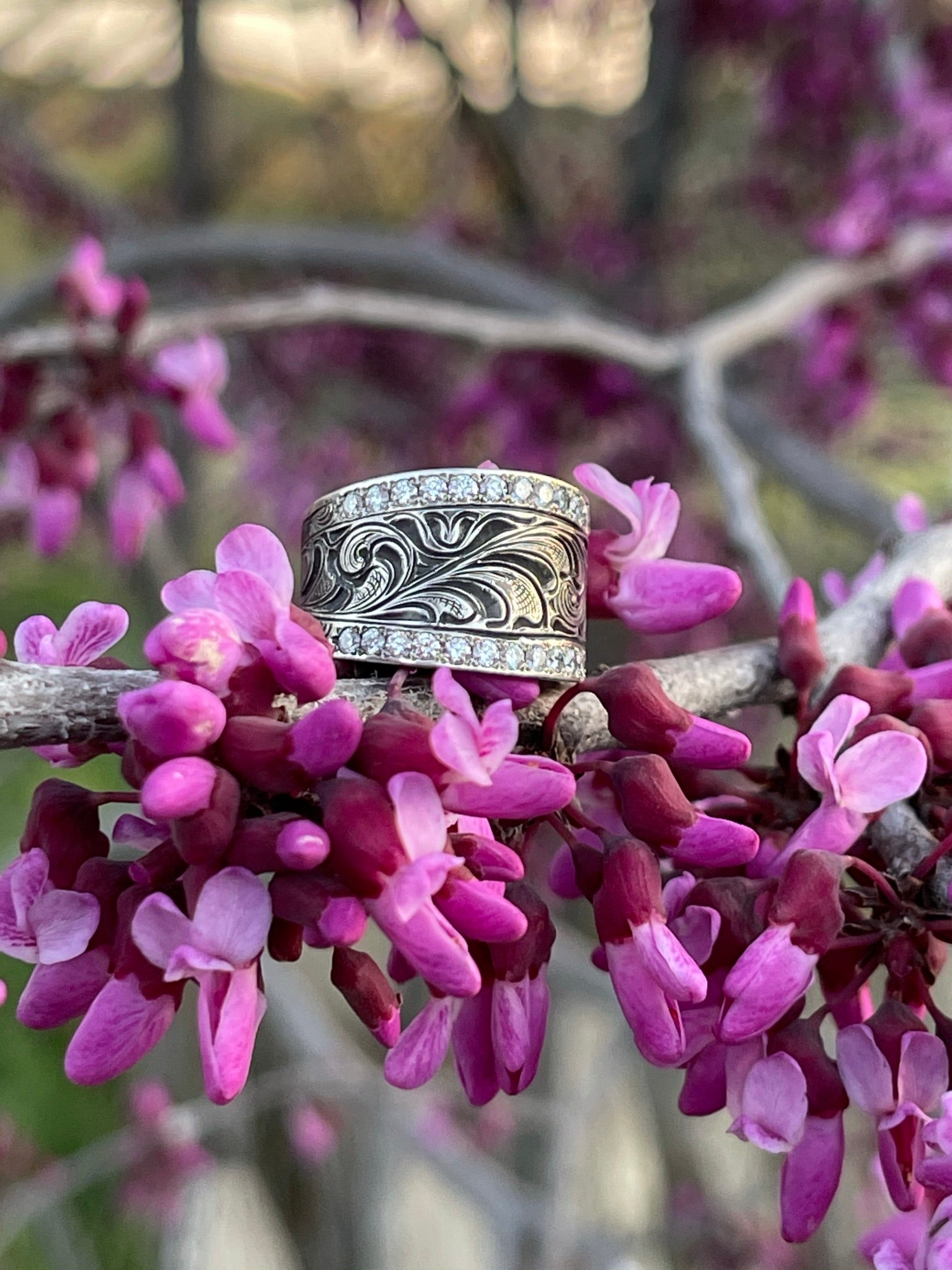 Close up of sterling silver ring with diamonds around edge