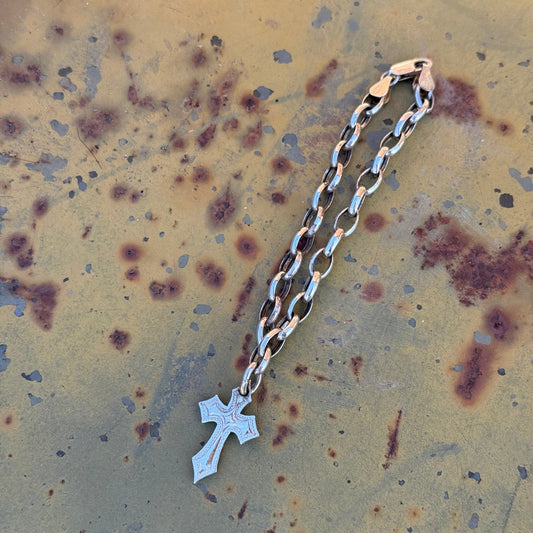 Hand-engraved sterling silver link bracelet with a small cross charm