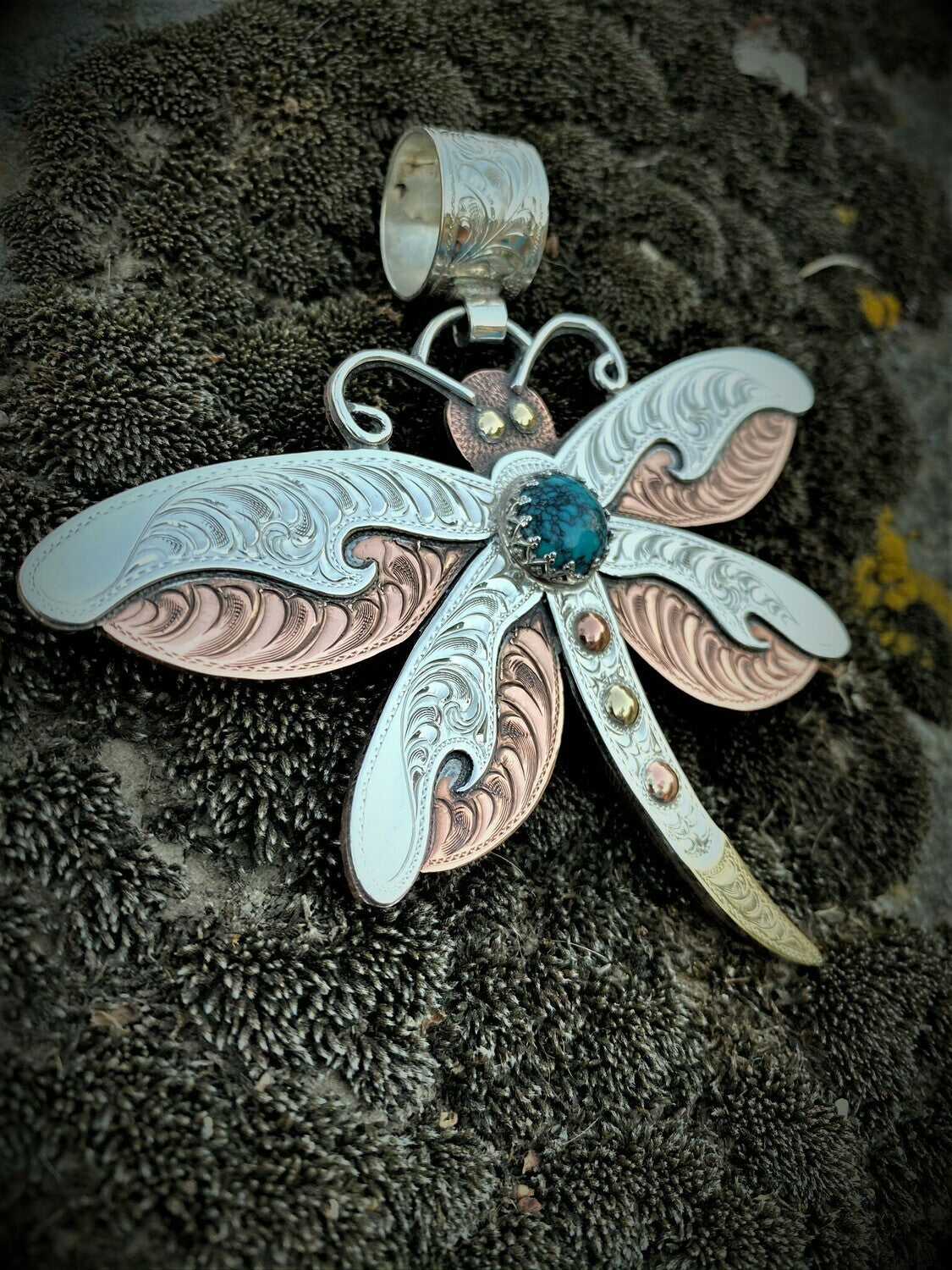 close up of sterling silver hand engraved dragonfly pendant